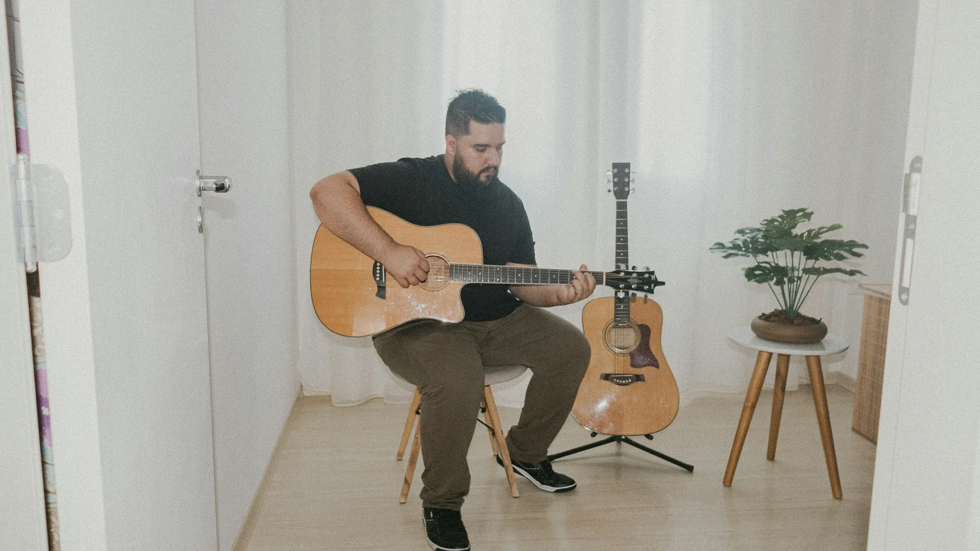 A fado singer and a Portuguese guitarist performing in a warm, candlelit Porto venue
