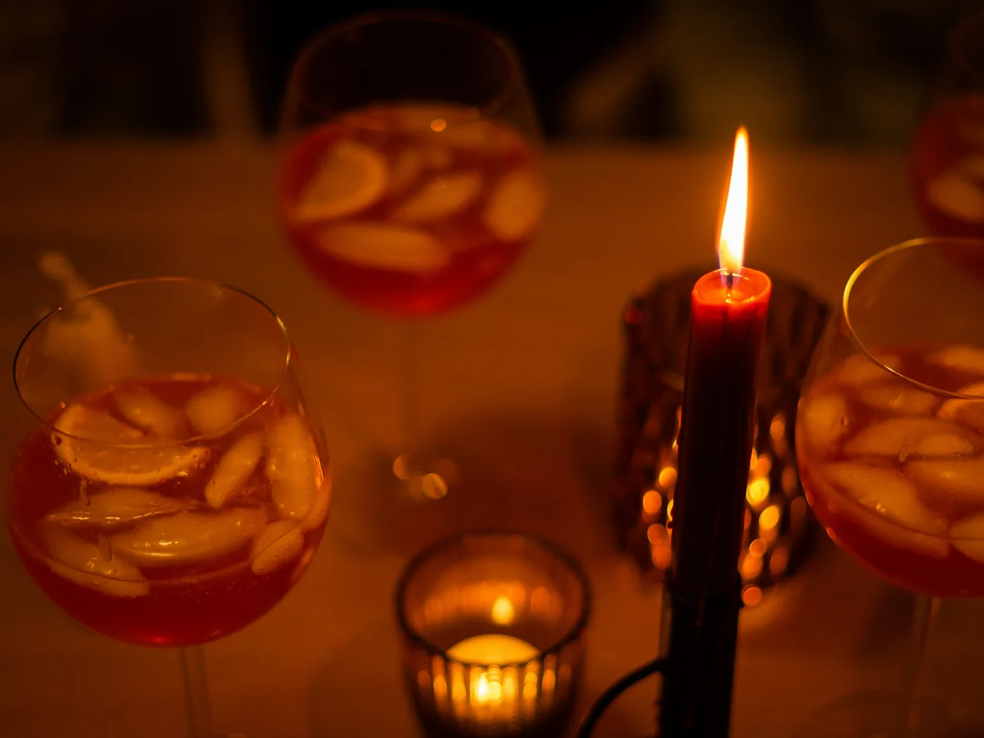 A glass of port wine in a warm candlelit setting